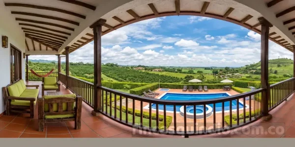 Terraza de Finca Montenegro Orquídea con vista a la piscina y al paisaje cafetero
